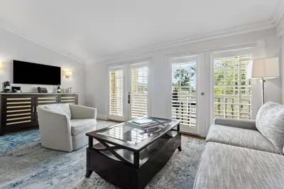 a living room with a couch and a coffee table at The Pillars Hotel & Club in Fort Lauderdale