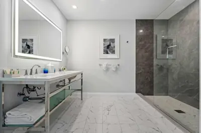 a bathroom with a sink and a shower at The Pillars Hotel & Club in Fort Lauderdale
