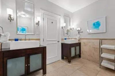 a bathroom with a tub and a sink and a mirror at The Pillars Hotel & Club in Fort Lauderdale