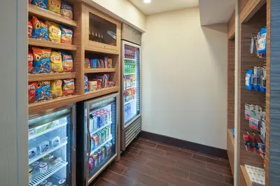 a grocery store aisle with two refrigerators at TownePlace Suites Miami Kendall West in Kendall