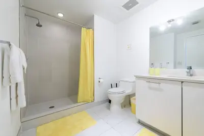 a bathroom with a shower and a toilet and a sink at Modern 1 Bedroom Midtown Miami with FREE Parking in Miami