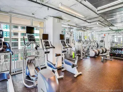 a gym with several treadmills and machines at Modern 1 Bedroom Midtown Miami with FREE Parking in Miami