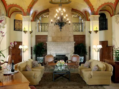 a living room with couches and a fireplace at Biltmore Hotel Miami Coral Gables in Miami