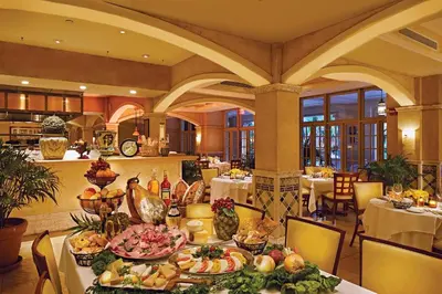 a dining room with a table with plates of food at Biltmore Hotel Miami Coral Gables in Miami