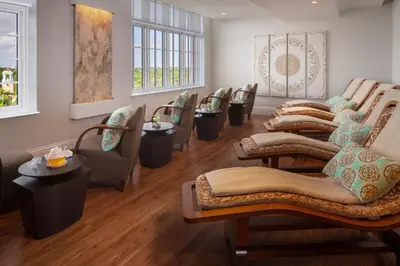 a waiting room with a row of chairs and tables at Biltmore Hotel Miami Coral Gables in Miami