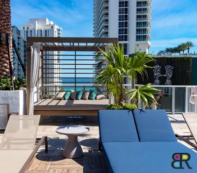 a patio with a couch and a table on a balcony at HYDE Beach House Apartments in Hollywood