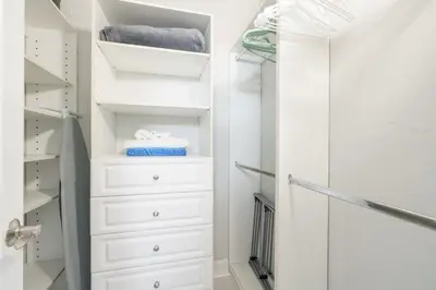 a walk in closet with white drawers and towels at OCEAN RESERVE 15th Floor - Gorgeous Ocean View - STR00907 in Miami Beach