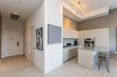 a kitchen with white cabinets and a counter top at Amazing Apartments at H Beach House in Hollywood