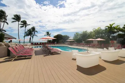 a pool with chaise lounge chairs and a bunch ofituresitures at Alexander 1211 Beachfront Condo with Direct Beach Access, 2 Pools, Sauna, Gym in Miami Beach