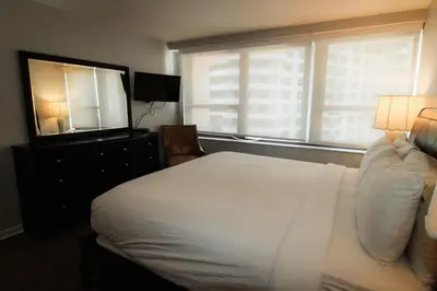 a bedroom with a white bed and a large window at Alexander 1209 Beachfront condo with 2 pools , beach access, sauna, stores in Miami Beach