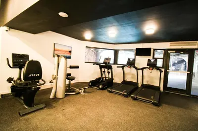 a gym with several treadmills and cardio machines at Alexander 1209 Beachfront condo with 2 pools , beach access, sauna, stores in Miami Beach