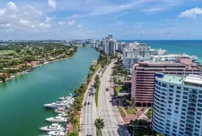 a view of a city with a river and buildings at Alexander 511 Beachfront condo with 2 pools, direct beach access, sauna, tikki bar in Miami Beach