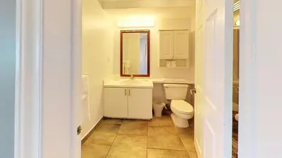 a bathroom with a toilet and a sink and a mirror at Castle M16 Oceanview Loft with Beach access, Pool, Tennis and Free Parking! in Miami Beach