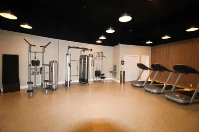 a gym with a bunch of cardio equipment in a room at Castle M16 Oceanview Loft with Beach access, Pool, Tennis and Free Parking! in Miami Beach