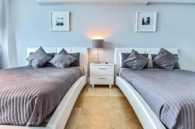 two beds sitting next to each other in a bedroom at Castle 828 Oceanfront view with balcony, pool, tennis, beach access and free parking! in Miami Beach