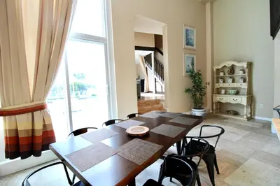 a dining room with a wooden table and chairs at Castle L1 Double-Loft Condo with Beach Access, Pool, Tennis and Free Parking! in Miami Beach