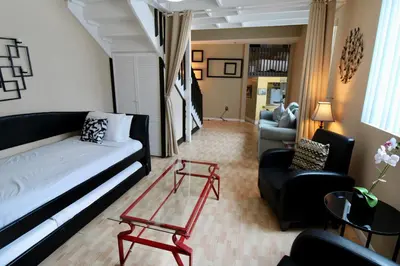 a living room with a couch and a chair at Castle L1 Double-Loft Condo with Beach Access, Pool, Tennis and Free Parking! in Miami Beach