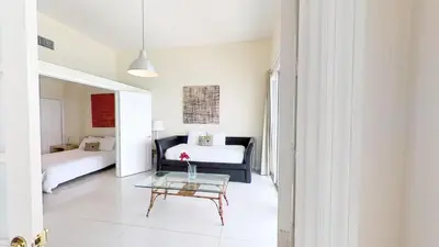 a room with a bed and a table and a couch at Castle Ph3 in Miami Beach