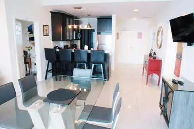 a dining room and kitchen with a glass table and chairs at Castle Ph3 in Miami Beach