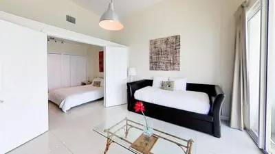 a bedroom with two beds and a glass table at Castle Ph3 in Miami Beach