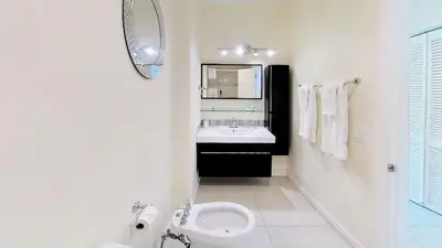 a white bathroom with a sink and a toilet at Castle Ph3 in Miami Beach