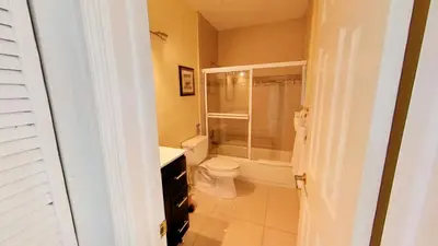 a bathroom with a toilet and a glass shower at Castle Ph3 in Miami Beach