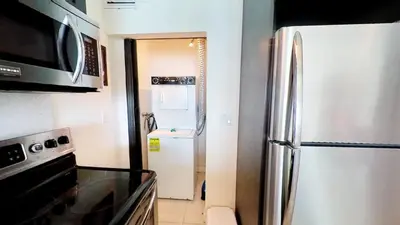 a kitchen with a refrigerator and a sink at Castle Ph3 in Miami Beach