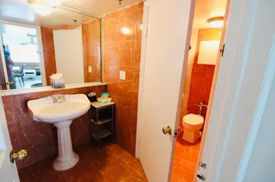 a bathroom with a sink and a toilet at Castle Th14 in Miami Beach