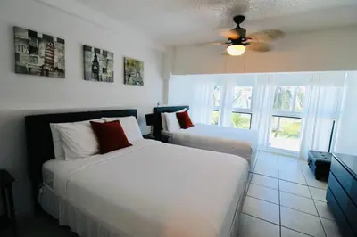a bedroom with two beds and a ceiling fan at Castle Th14 in Miami Beach