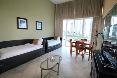 a living room with a couch and a table at Castle B17 Contemporary Condo with Pool, Beach Access and Free Parking in Miami Beach
