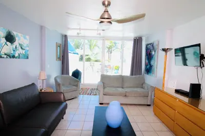 a living room with a couch and a table at Castle Th16 Beachfront Townhouse with private patio, direct beach access, pool, tennis & free parking! in Miami Beach