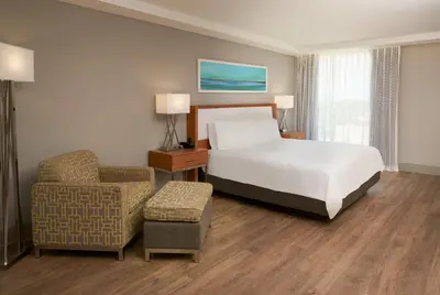 a hotel room with a bed and a chair at DoubleTree by Hilton Miami North I-95 in Miami
