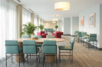 a waiting room with a table and chairs at DoubleTree by Hilton Miami North I-95 in Miami