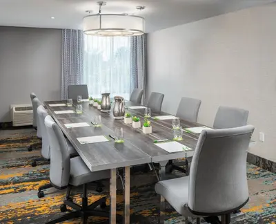 a conference room with a long table and chairs at DoubleTree by Hilton Miami North I-95 in Miami