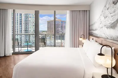 a bedroom with a large white bed and a large window at Hyatt Centric Las Olas Fort Lauderdale in Fort Lauderdale
