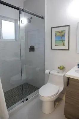 a bathroom with a toilet and a glass shower at Apt 1 Miami Designer Studio in the Upper East-Side in Miami