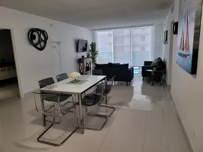 a dining room and living room with a table and chairs at Paradise on Hollywood Beach 2 bed 2 bath in Hollywood