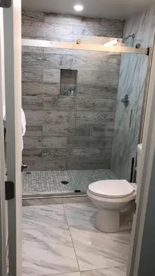 a bathroom with a shower with a toilet and a glass door at The Drift Hotel in Fort Lauderdale