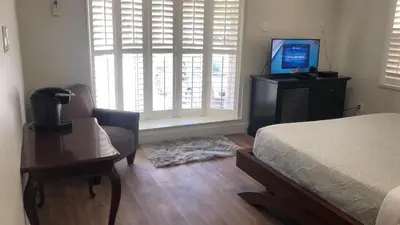 a bedroom with a bed and a desk and a television at The Drift Hotel in Fort Lauderdale