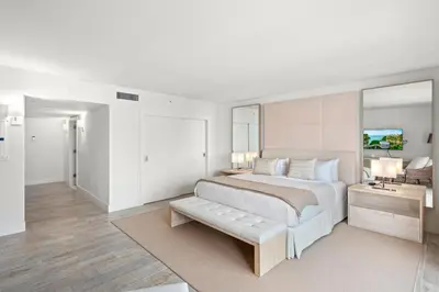 a white bedroom with a large bed and a couch at Oceanfront Private Condo at 1 Hotel & Homes -1219 in Miami Beach