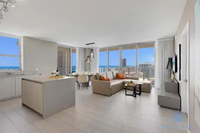 a kitchen and a living room with a couch and a table at Wrap Around Balcony - Insane Views - Amazing Pools in Hollywood