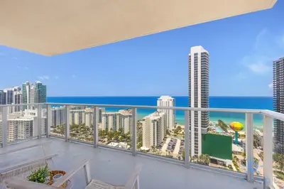 a balcony with a view of the beach and the ocean at Wrap Around Balcony - Insane Views - Amazing Pools in Hollywood