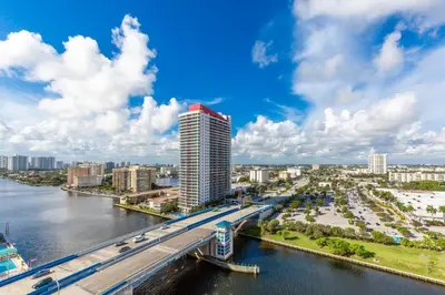 a view of a city with a bridge and a river at Ocean Breeze Retreat - Pool Gym Access Views in Hallandale Beach