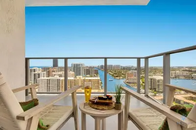 a balcony with a table and a view of the city at Luxury 3 Br- Front Intercostal View - Amazing Pools in Hollywood