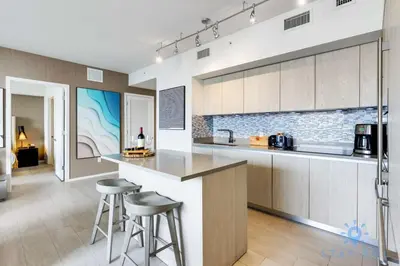 a kitchen with a counter and stools in a room at Luxury 1Br-Front Intracoastal View Balcony - Pools in Hollywood