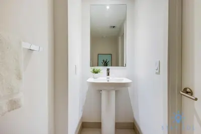 a white bathroom with a sink and a mirror at Luxury 1Br-Front Intracoastal View Balcony - Pools in Hollywood