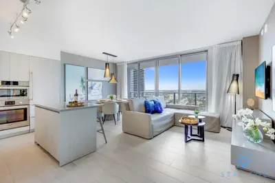 a kitchen and living room with a couch and a table at Luxury 1Br-Front Intracoastal View Balcony - Pools in Hollywood