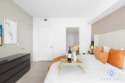 a bedroom with a bed with a table with wine bottles at Wrap Around Balcony - Paradise Beach - Amazing Pools in Hollywood