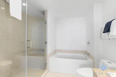 a white bathroom with a shower and a bath tub at Wrap Around Balcony - Paradise Beach - Amazing Pools in Hollywood