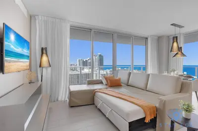 a living room with a couch and large windows at High-Floor with Stunning Views-Luxury Condo - Pools in Hollywood